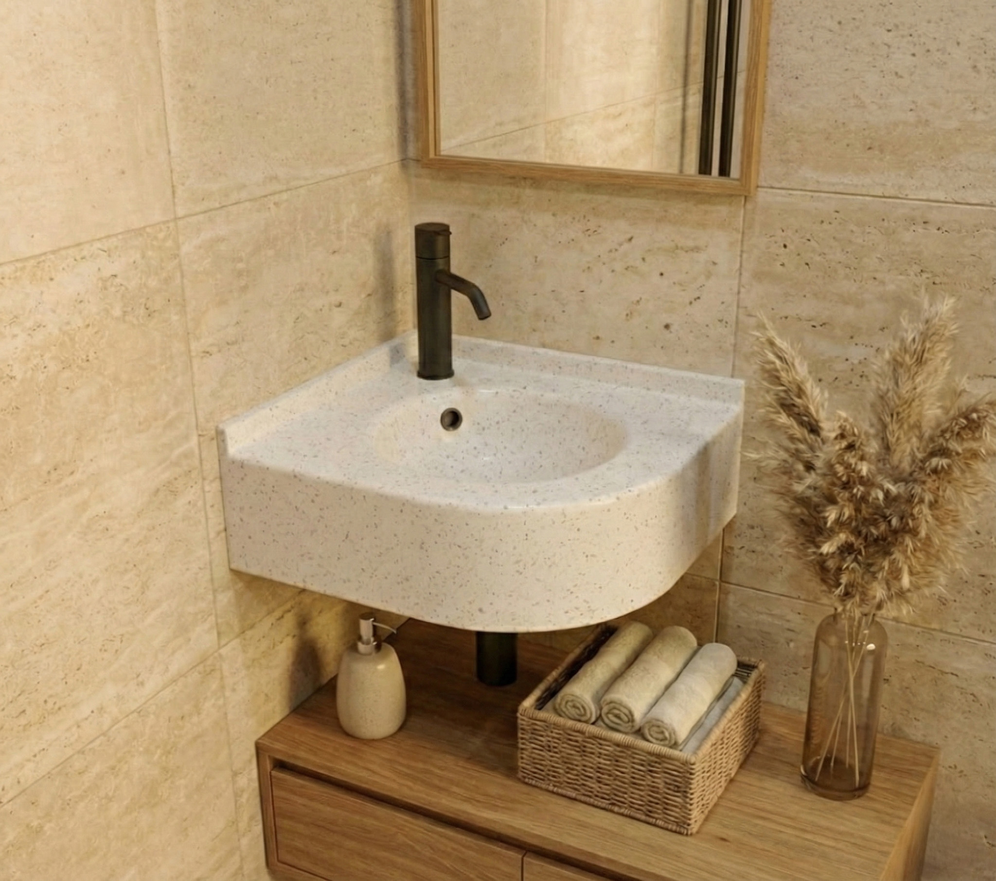 A bright bathroom design featuring a curved corner sink in Everest Corian, which has a clean white base with subtle grey and translucent speckles. The setup includes a matte black faucet, warm beige wall tiles, and a wooden vanity unit with a wicker basket and pampas grass decor.