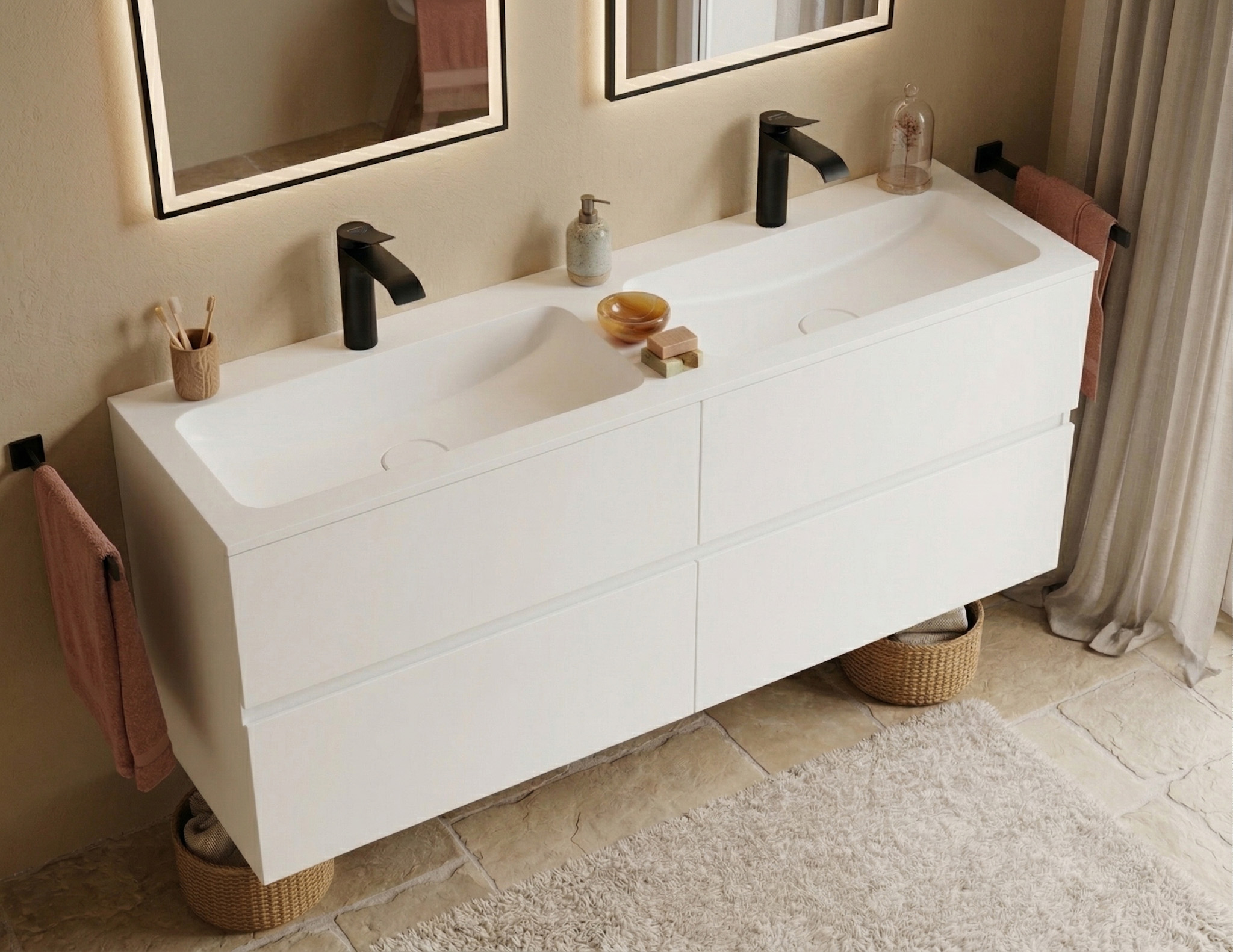A modern, harmonious bathroom featuring a seamless white Corian floating vanity with an integrated double sink. The sleek vanity unit provides ample storage with large, handleless double drawers. Two matte black faucets sit above the rectangular basins, matching the dark towel bars and the frames of the two backlit mirrors above. The warm, beige-toned space is decorated with natural bath accessories, woven storage baskets tucked underneath, a plush beige rug, and textured stone floor tiles, creating a cozy and inviting atmosphere.